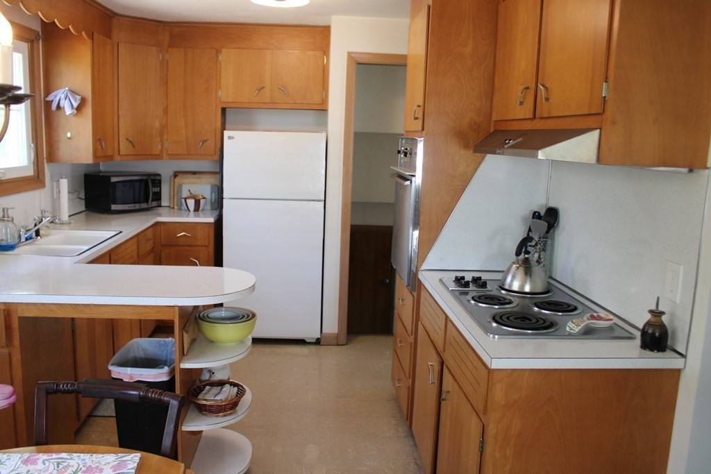 295 Draper Street Springfield, MA 01108 - Photo 7 of 31 a kitchen with a refrigerator and a stove