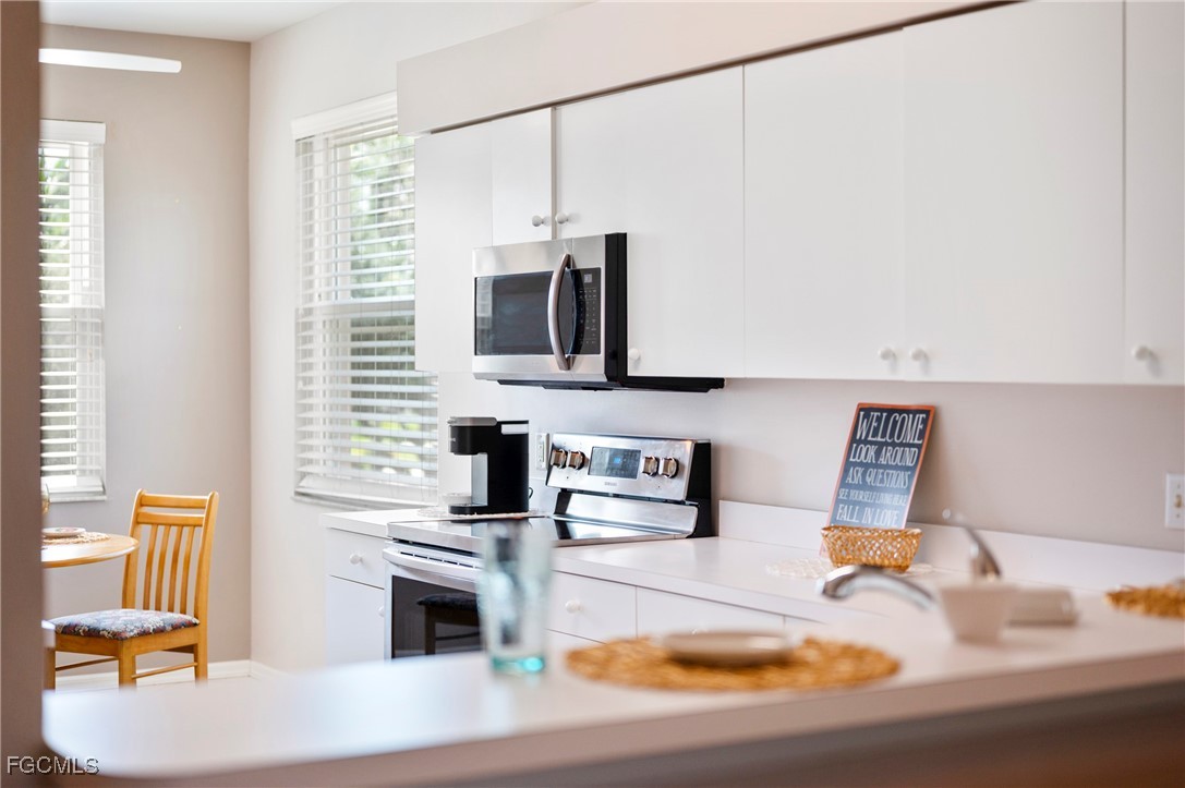 14091 Brant Point Circle, Unit 4201 Fort Myers, FL 33919 - Photo 12 of 23 a kitchen with a sink appliances and cabinets