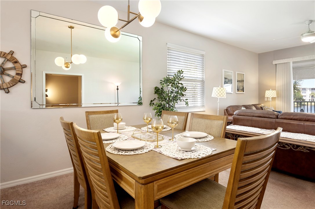 14091 Brant Point Circle, Unit 4201 Fort Myers, FL 33919 - Photo 13 of 23 a dining room with furniture and wooden floor