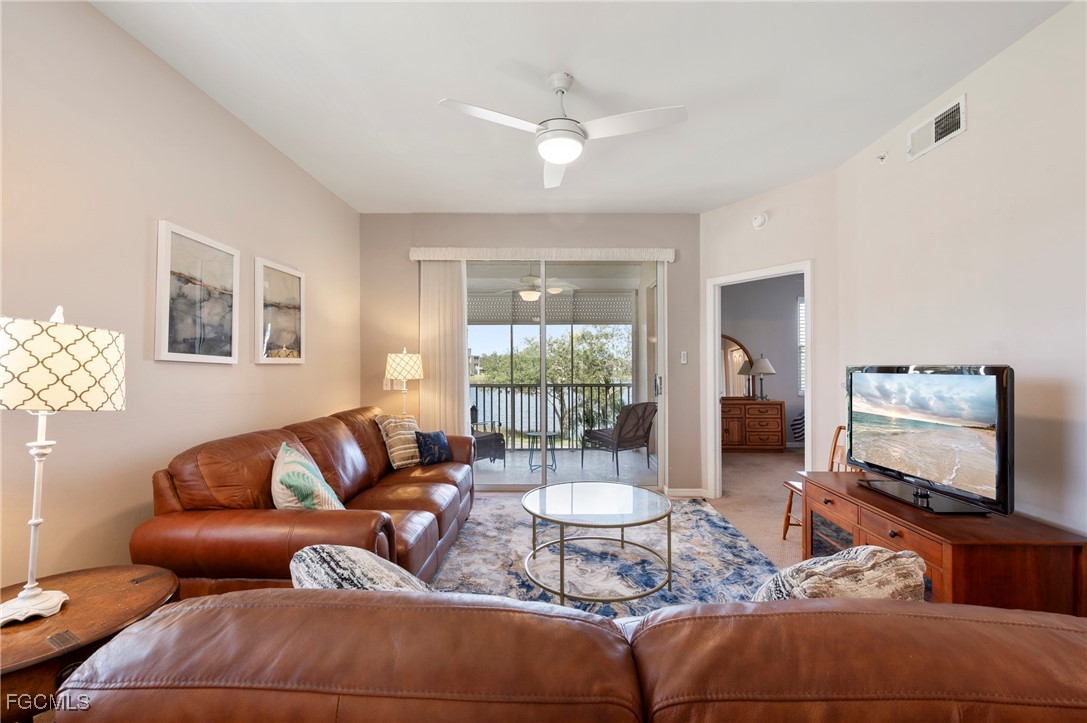 14091 Brant Point Circle, Unit 4201 Fort Myers, FL 33919 - Photo 17 of 23 a living room with furniture a flat screen tv and a large window