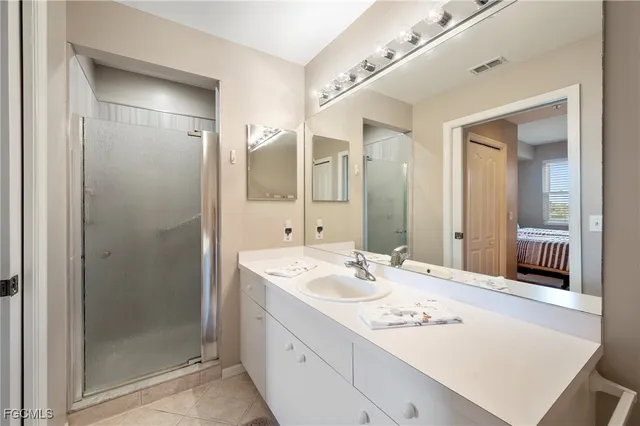 a bathroom with a sink a shower a mirror and a bathtub