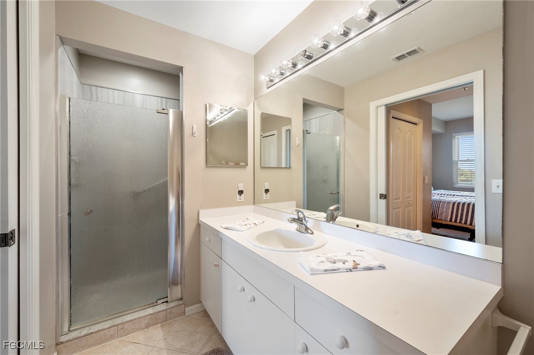 14091 Brant Point Circle, Unit 4201 Fort Myers, FL 33919 - Photo 21 of 23 a bathroom with a sink a shower a mirror and a bathtub