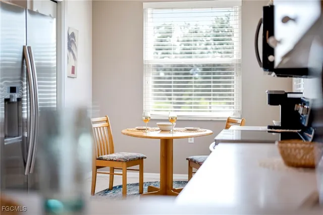 a dining room with furniture and a window