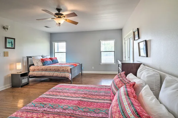 a bedroom with a bed chandelier and a window