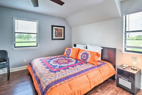 a bedroom with a bed lamp and a window