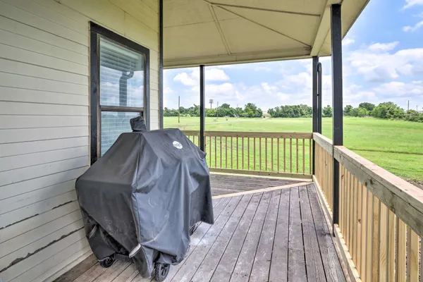 a view of balcony with wooden floor and fence
