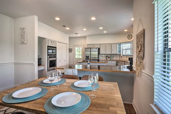 a dining room with furniture a table and kitchen view