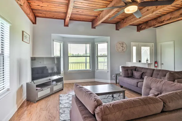 a living room with furniture and wooden floors