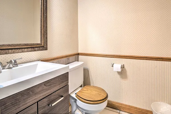 a bathroom with a sink a toilet and a mirror