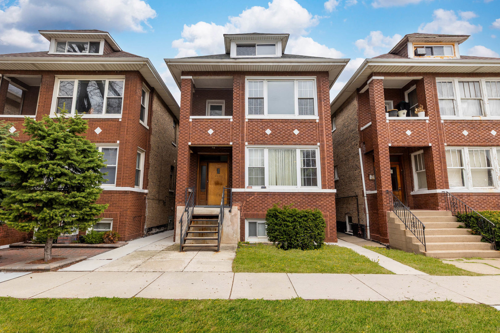 2630 West 42nd Street, Unit 2 Chicago, IL 60632 - Photo 1 of 12 a front view of a house with garden