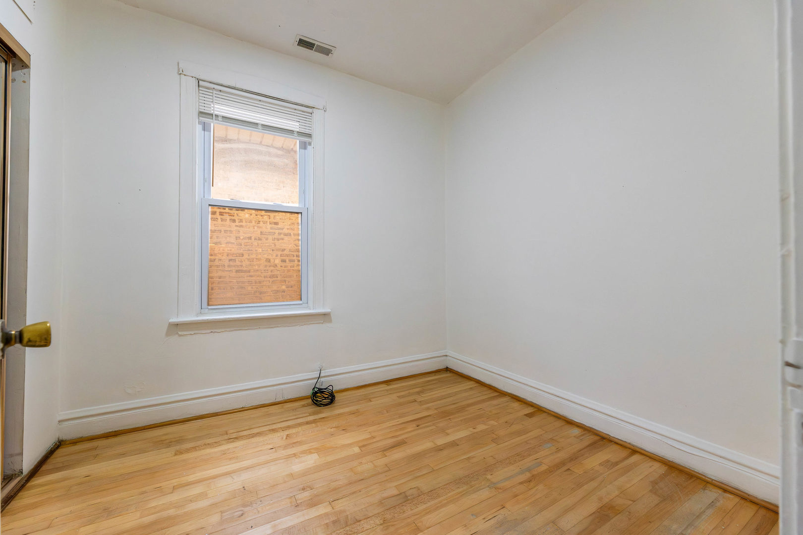 2630 West 42nd Street, Unit 2 Chicago, IL 60632 - Photo 11 of 12 an empty room with a window