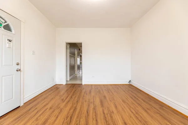 a view of a room with wooden floor