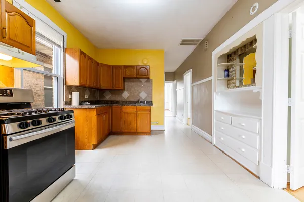a kitchen with stainless steel appliances a stove a sink and a refrigerator