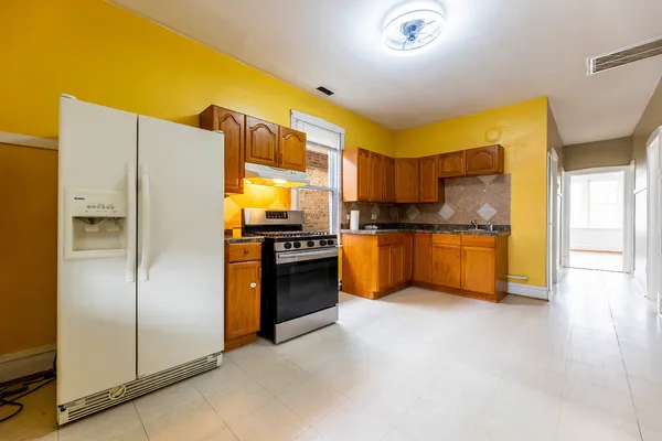 a kitchen with stainless steel appliances a refrigerator and a stove