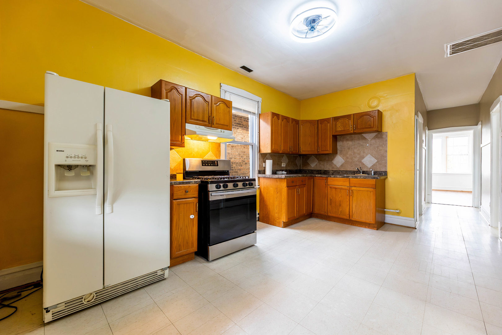 2630 West 42nd Street, Unit 2 Chicago, IL 60632 - Photo 7 of 12 a kitchen with stainless steel appliances a refrigerator and a stove