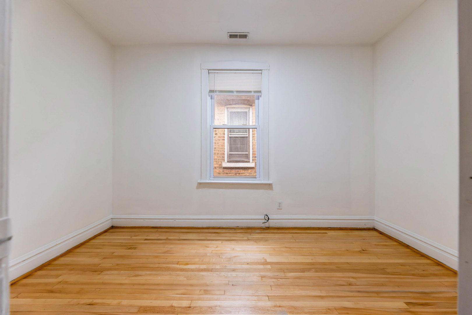 2630 West 42nd Street, Unit 2 Chicago, IL 60632 - Photo 8 of 12 a view of empty room with wooden floor and fan
