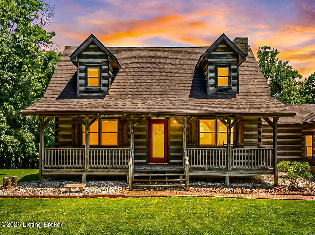 Hand-crafted log cabin on a private acre with the Nolin River rolling through your backyard.