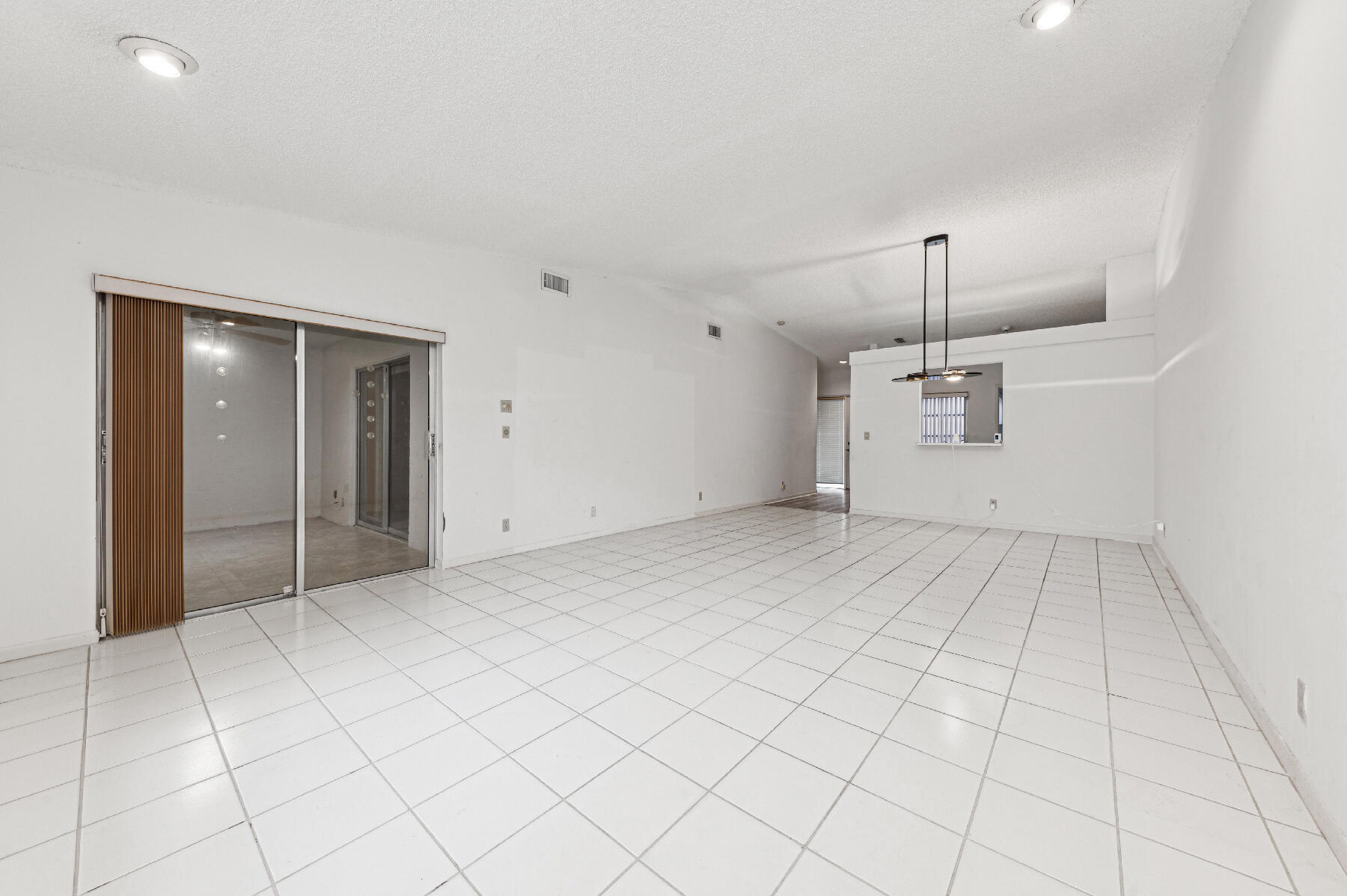 8191 Sweetbriar Way Boca Raton, FL 33496 - Photo 3 of 10 an empty room with white walls and tiles