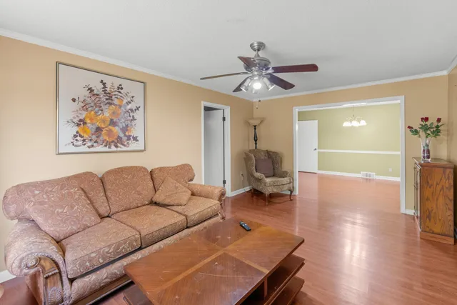a living room with furniture and wooden floor