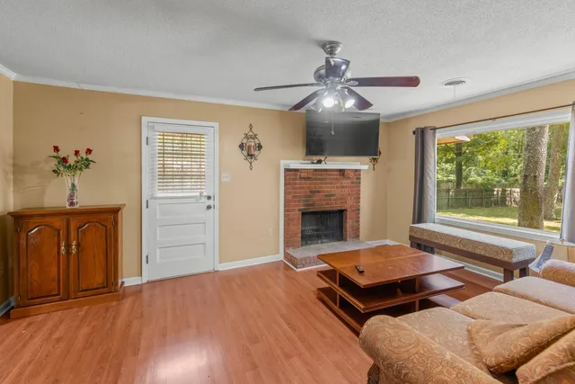 a living room with furniture a window and a fireplace