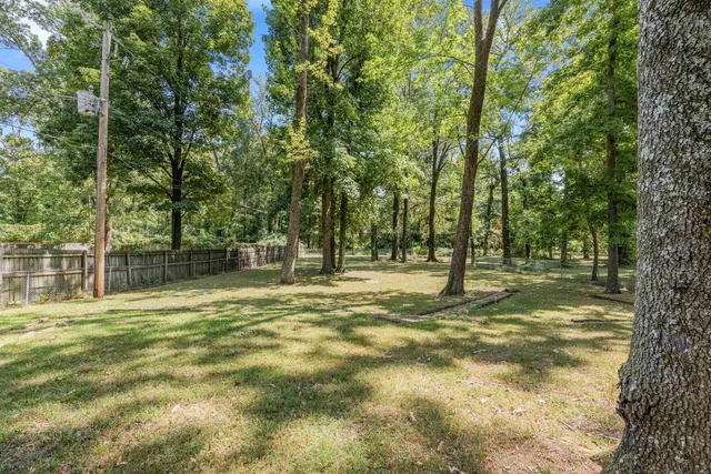 a swimming pool with trees in the background