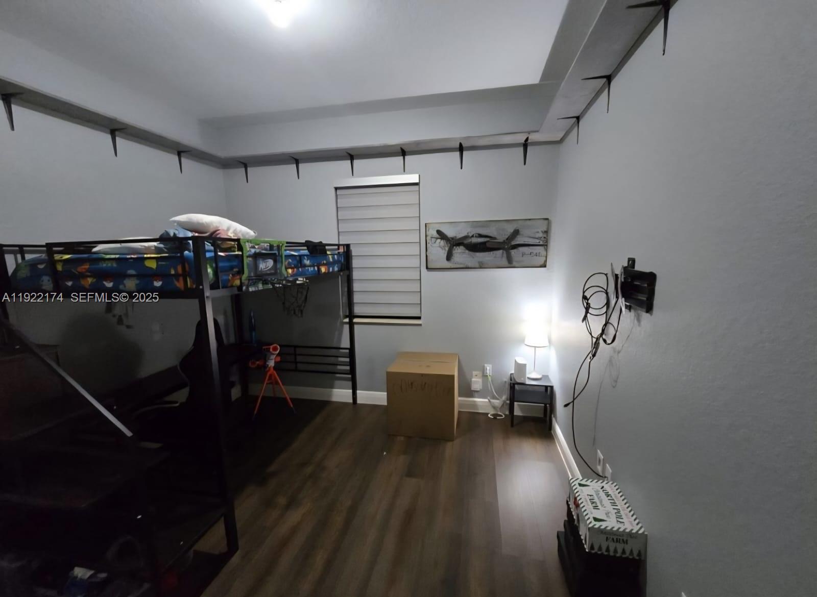 27862 Southwest 134th Court Homestead, FL 33033 - Photo 11 of 14 a view of a workspace with furniture and wooden floor