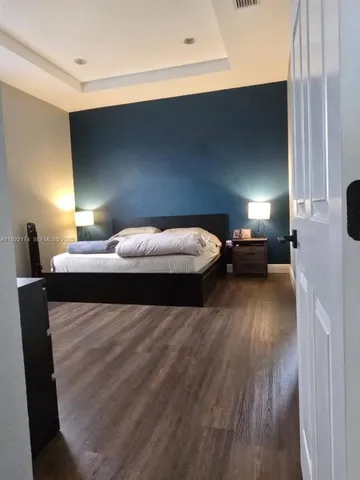 a bedroom with a bed and a night stand