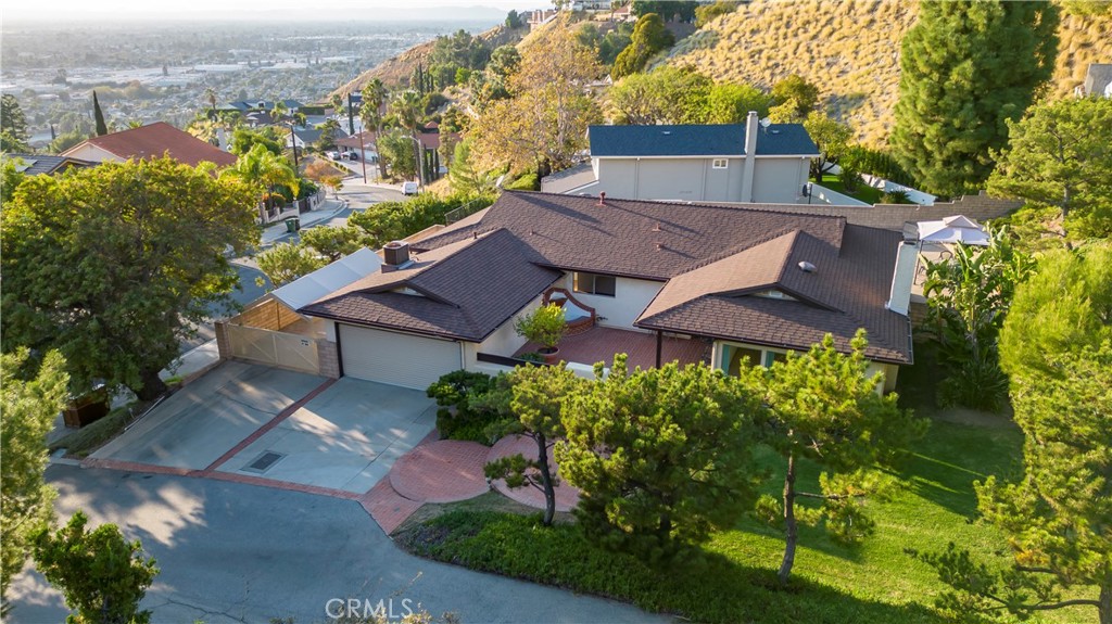 an aerial view of a house with a garden and plants