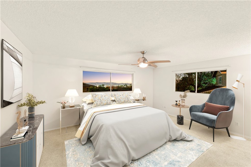 9869 Lanark Street Sun Valley, CA 91352 - Photo 12 of 22 a bedroom with a bed a couch and large window