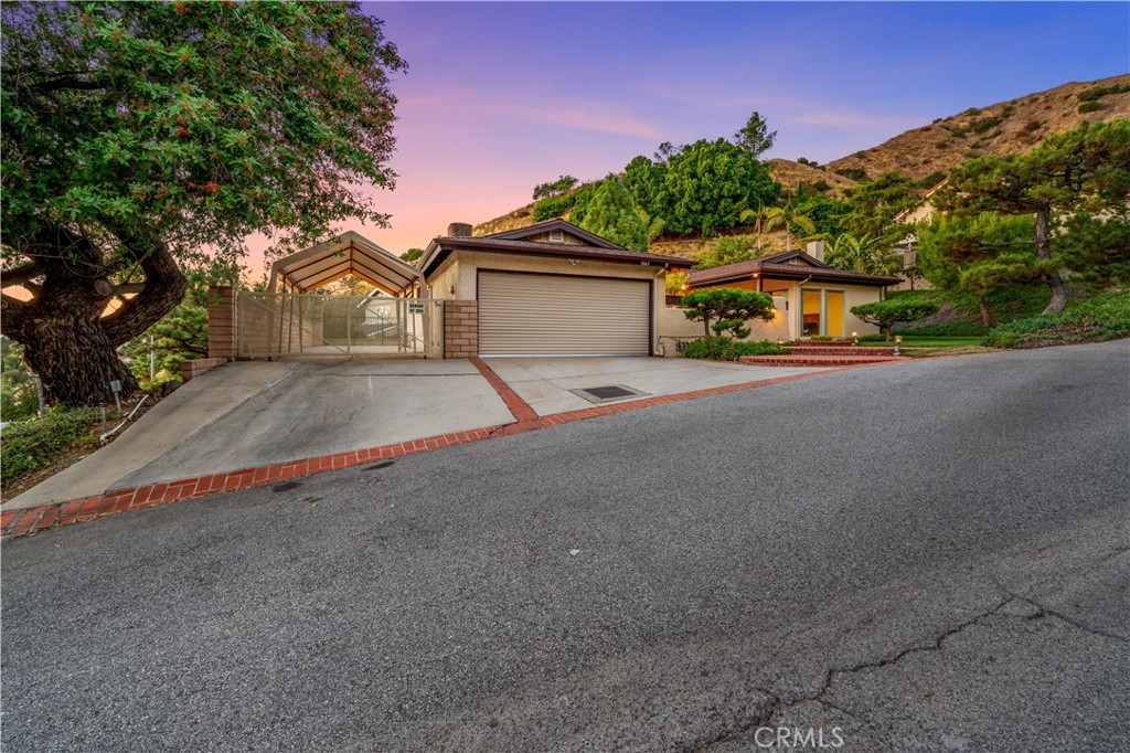 9869 Lanark Street Sun Valley, CA 91352 - Photo 2 of 22 a front view of a house with a yard and garage