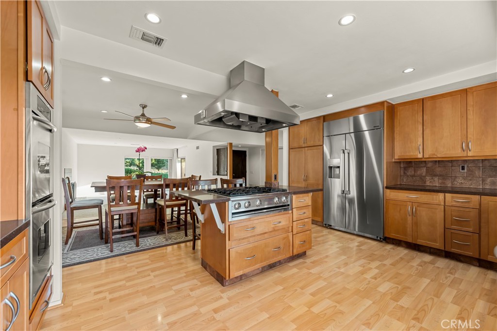 9869 Lanark Street Sun Valley, CA 91352 - Photo 9 of 22 a kitchen with stainless steel appliances granite countertop a stove oven and a refrigerator with cabinets