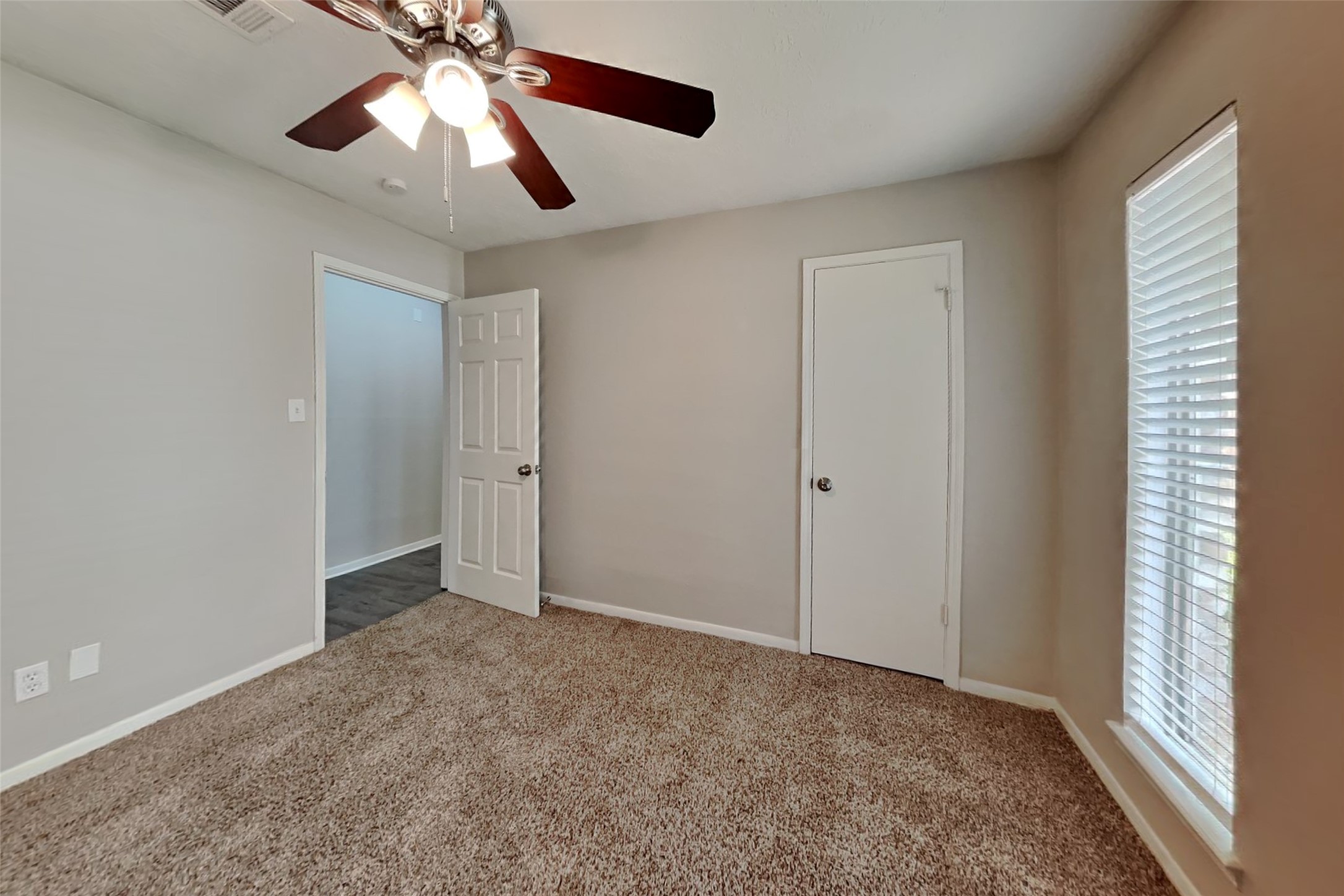 29307 Atherstone Street Spring, TX 77386 - Photo 14 of 22 an empty room with closet and a chandelier fan