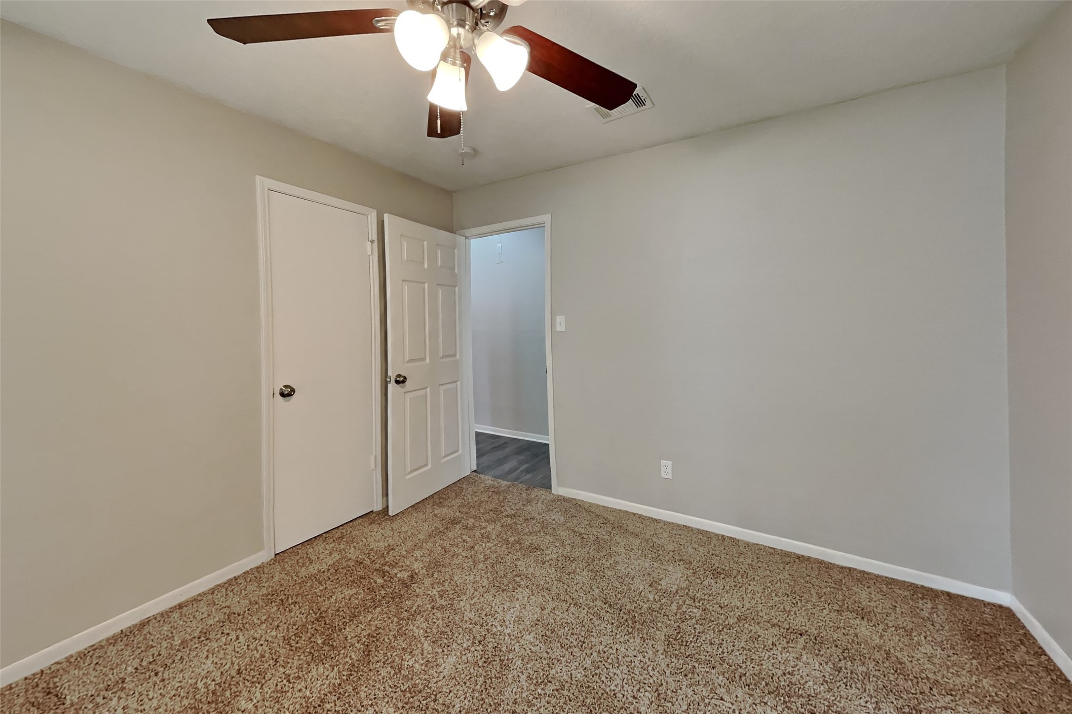 29307 Atherstone Street Spring, TX 77386 - Photo 18 of 22 an empty room with a chandelier fan and closet area