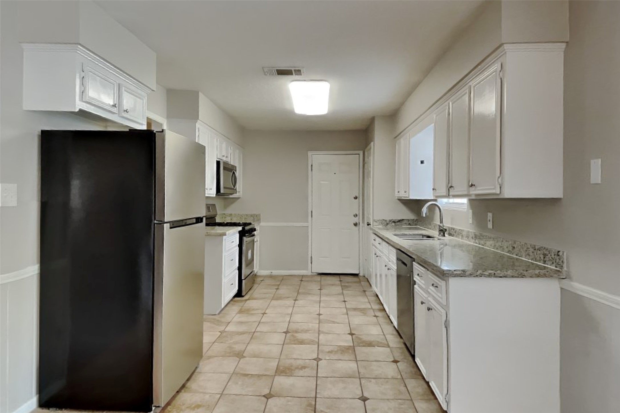 29307 Atherstone Street Spring, TX 77386 - Photo 4 of 22 a kitchen with granite countertop a refrigerator and a sink