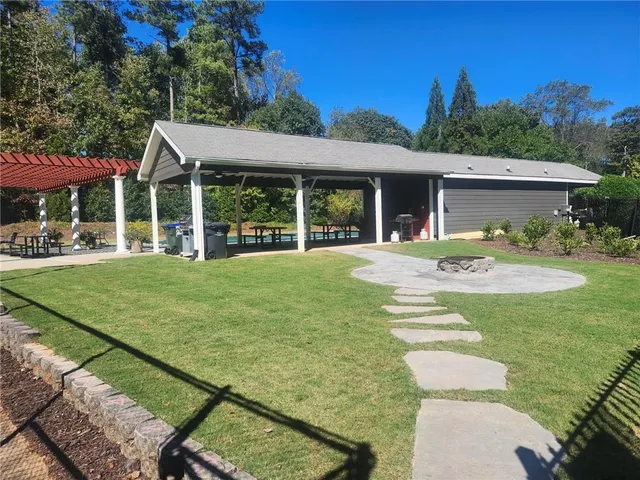 a view of a house with a yard patio and a garden