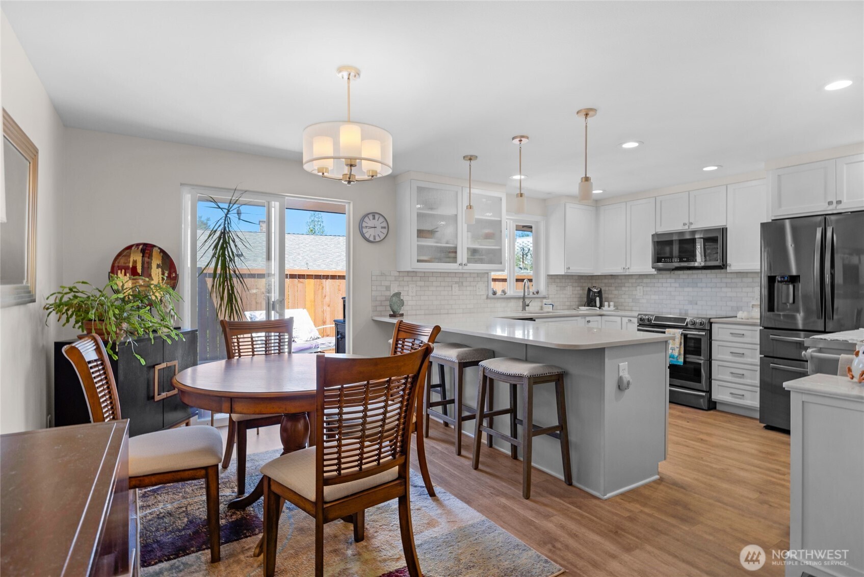 205 Heather Road Everett, WA 98203 - Photo 12 of 40 a view of a dining room with furniture a chandelier and wooden floor
