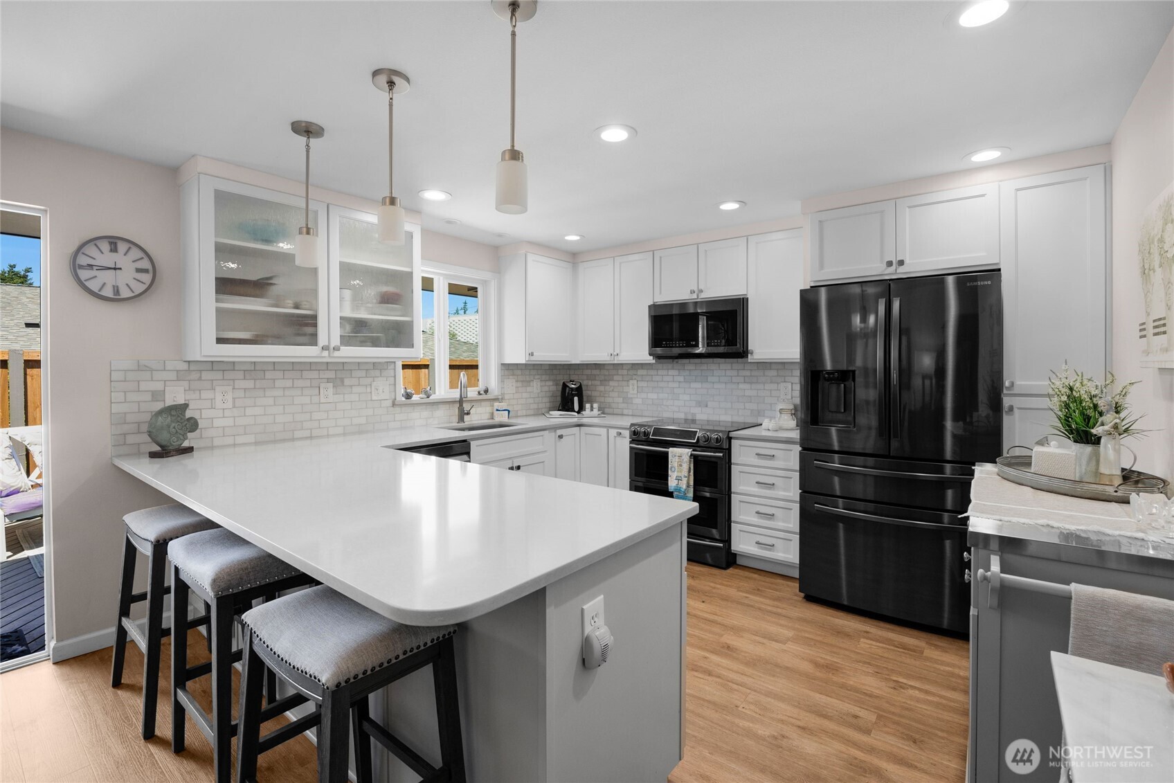 205 Heather Road Everett, WA 98203 - Photo 13 of 40 a kitchen with kitchen island a counter space a sink appliances and cabinets