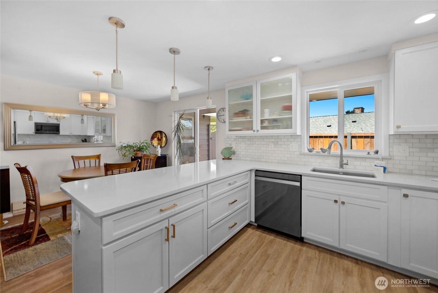205 Heather Road Everett, WA 98203 - Photo 14 of 40 a kitchen with white cabinets and sink