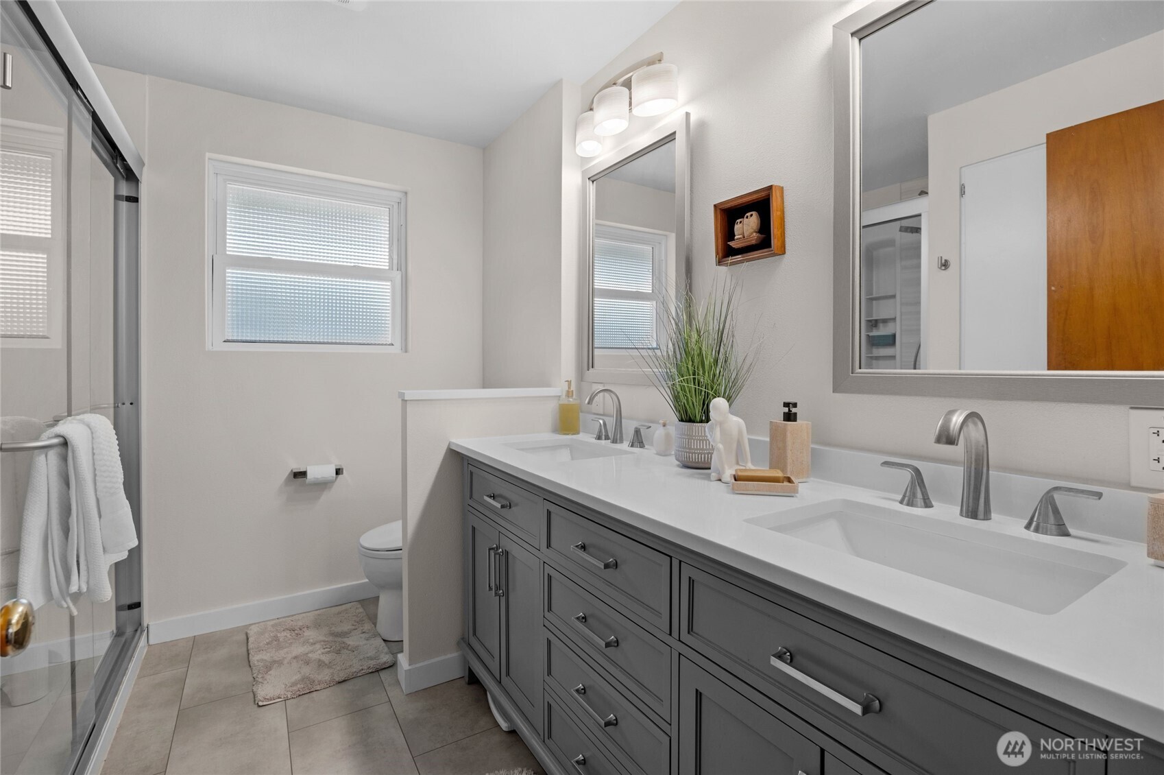 205 Heather Road Everett, WA 98203 - Photo 18 of 40 a bathroom with a double vanity sink toilet and mirror