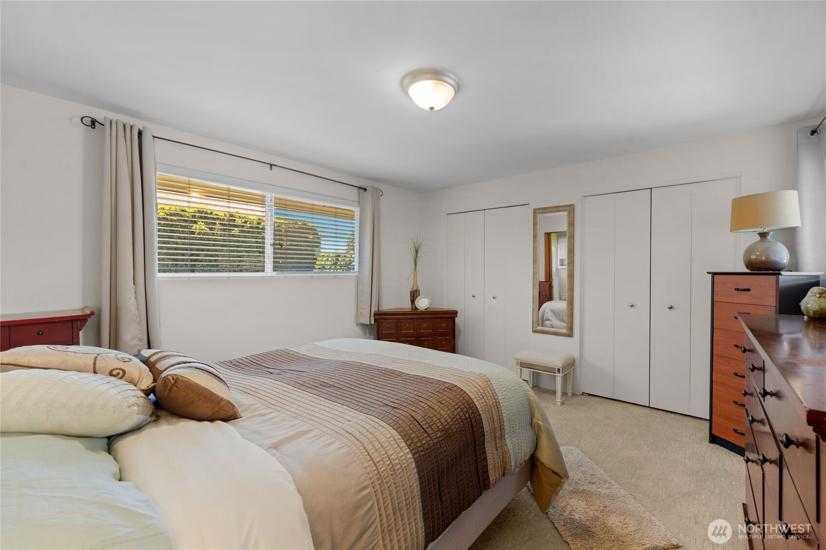 205 Heather Road Everett, WA 98203 - Photo 19 of 40 a bedroom with a bed and a lamp