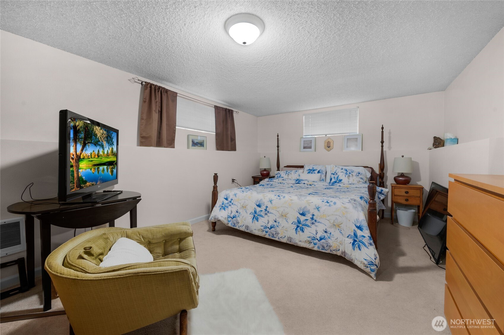 205 Heather Road Everett, WA 98203 - Photo 22 of 40 a bedroom with a bed and a flat screen tv