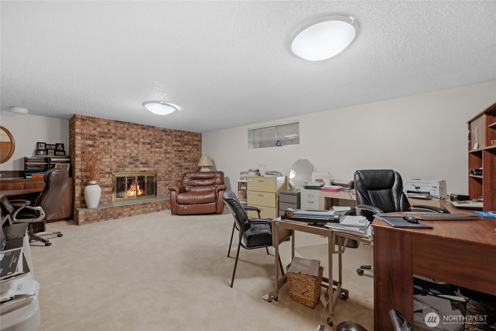 205 Heather Road Everett, WA 98203 - Photo 23 of 40 a view of a workspace with furniture and a fireplace