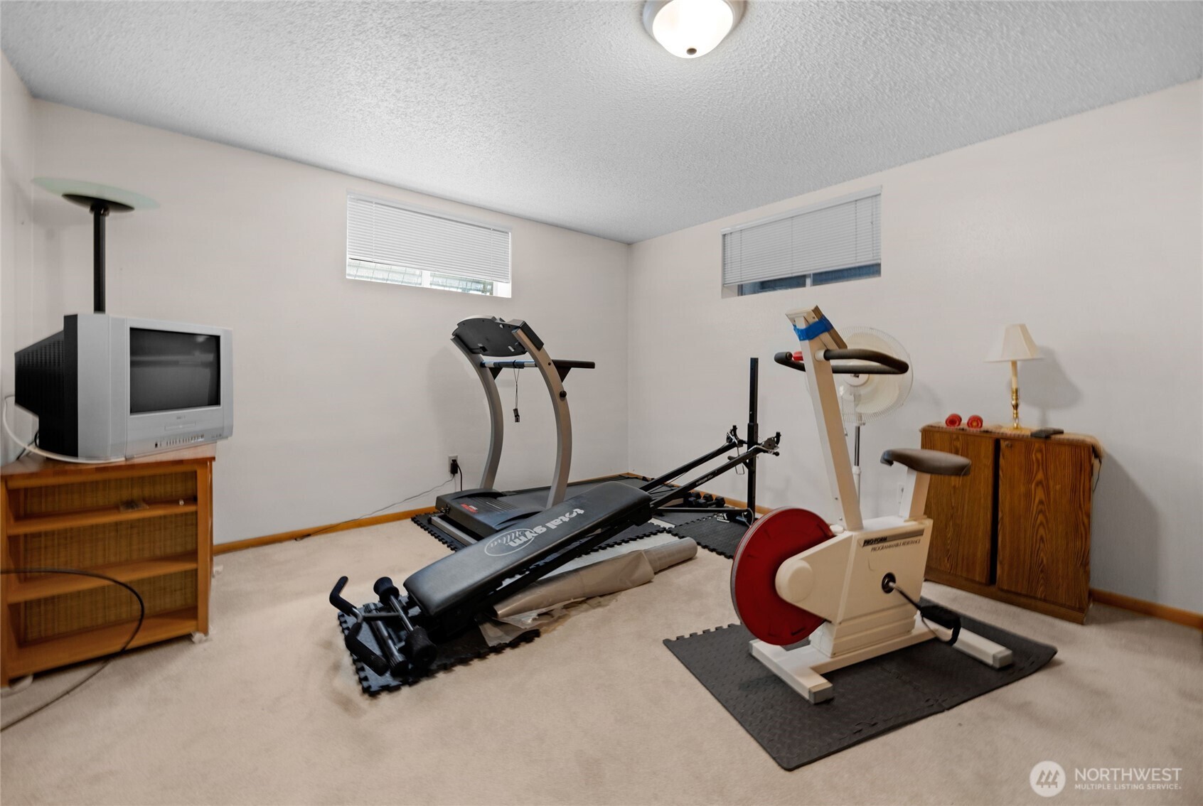 205 Heather Road Everett, WA 98203 - Photo 24 of 40 a room with gym equipment and windows