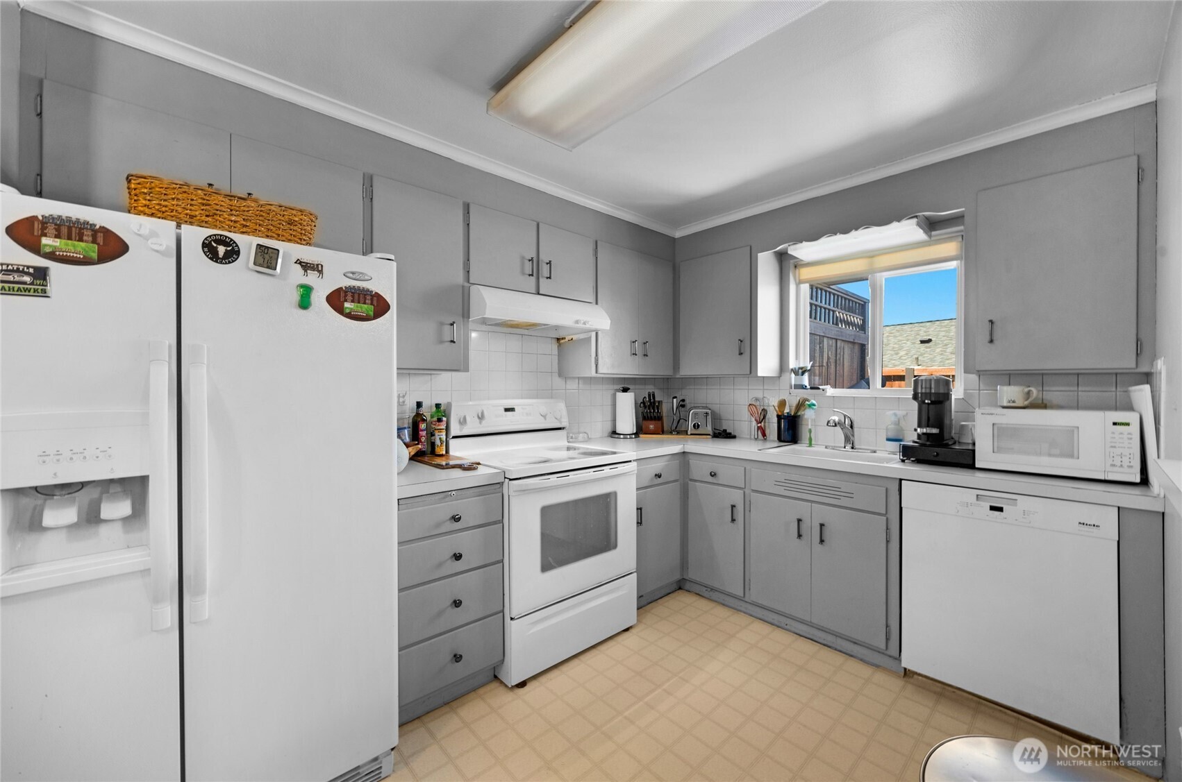 205 Heather Road Everett, WA 98203 - Photo 33 of 40 a kitchen with white cabinets and white appliances