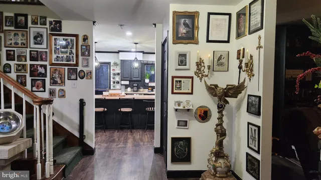 a living room with stainless steel appliances kitchen island granite countertop a refrigerator a stove a microwave and a sink