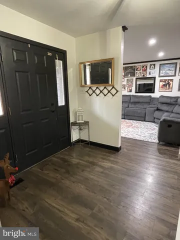 a living room with furniture tv and a window
