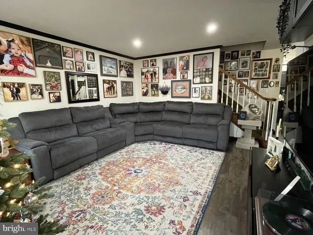 a view of a livingroom with furniture and bookshelf