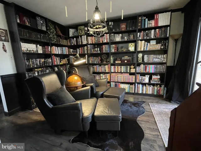 a living room with lots of furniture and a book shelf