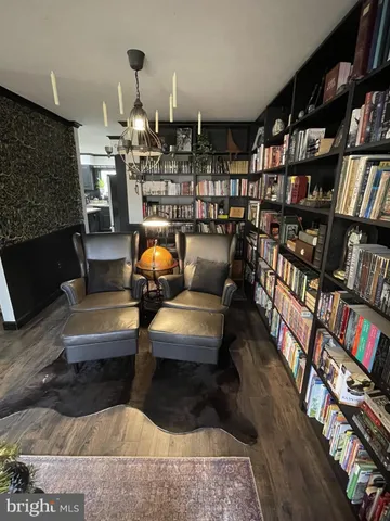 a kitchen with a table chairs refrigerator and microwave