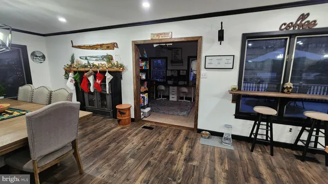 a living room with lots of furniture and kitchen view